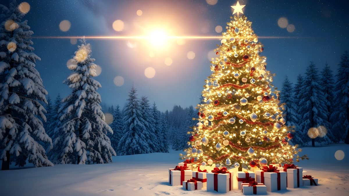 Illuminated christmas tree with gift boxes in a snowy forest at night stock photo