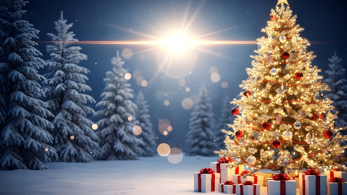 Illuminated christmas tree with gift boxes in a snowy forest at night stock photo