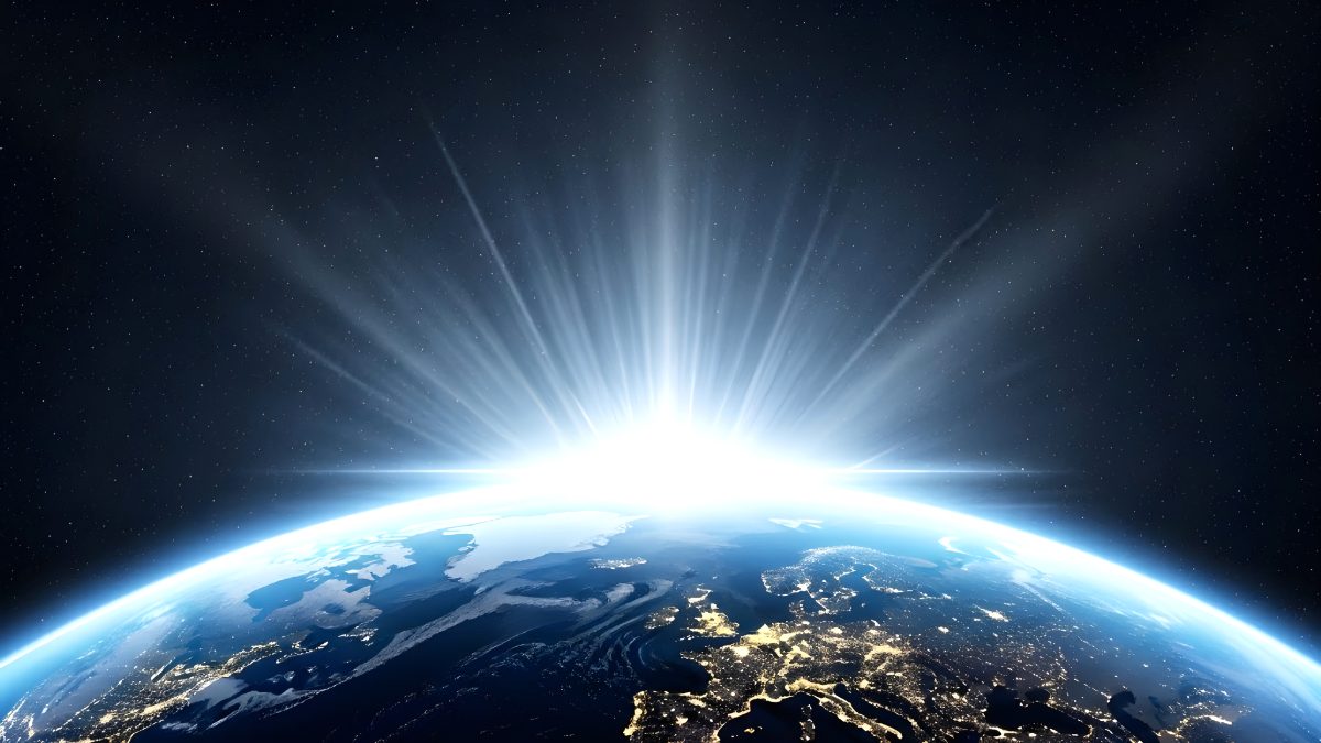 Bright sunrise over planet earth seen from space with glowing city lights and starry night sky stock photo